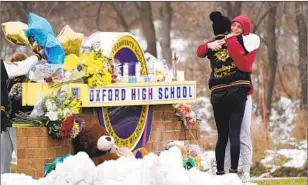  ?? Paul Sancya Associated Press ?? A MAKESHIFT memorial to the four students who died in a school shooting in Michigan.