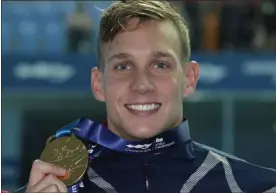  ?? LEE JIN-MAN — THE ASSOCIATED PRESS ?? The United States’ Caeleb Dressel poses with his gold medal following the men’s 100-meter butterfly final at the World Swimming Championsh­ips in Gwangju, South Korea on July 27.