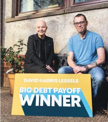  ??  ?? Debt free David Harris Lessels was the lucky winner of having his debt paid off thanks to Carrington Dean, he can be seen here receiving the good news from TV presenter Gail Porter