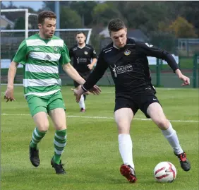  ??  ?? Colin Melody, Rineanna Rovers, is chased by Gary Keane, Killarney Celtic, in the FAI Junior Cup at Celtic Park, Killarney on Saturday.