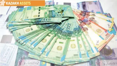  ?? — Reuters ?? New tenge banknotes are displayed in this picture illustrati­on in Almaty, Kazakhstan.