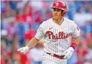  ?? AP PHOTO/CHRIS SZAGOLA ?? The Phillies’ J.T. Realmuto reacts to his home run during the first inning against the Atlanta Braves on Friday.