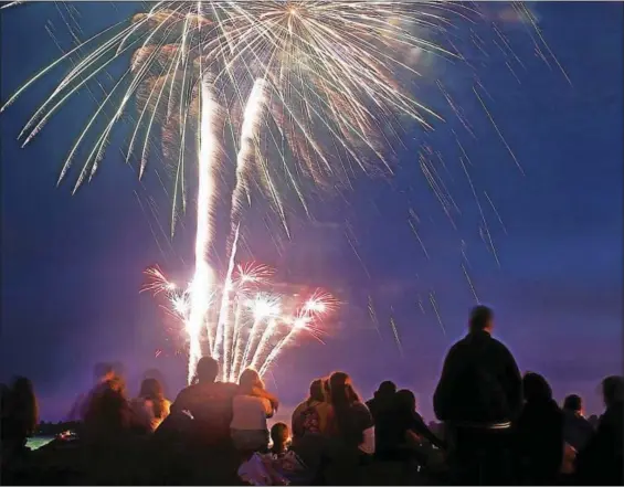  ?? PETER CASOLINO FILE PHOTO ?? Spectators enjoy the annual fireworks display at Bradley Point In West Haven.