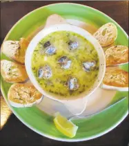  ??  ?? An appetizer of escargot with toasted baguette rounds.