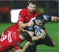  ??  ?? Held: Toulon’s Raphael Lakafia is tackled by David Bulbring and Gareth Davies