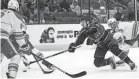  ?? JOSEPH SCHELLER/COLUMBUS DISPATCH ?? Blue Jackets forward Jack Roslovic battles for the puck against the Flames.