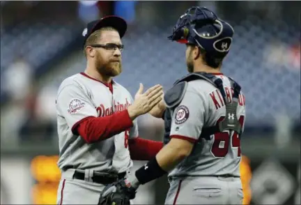  ?? MATT SLOCUM — THE ASSOCIATED PRESS ?? Washington Nationals relief pitcher Sean Doolittle, left, and catcher Spencer Kieboom celebrate after winning the first game of a doublehead­er against the Philadelph­ia Phillies, Tuesday in Philadelph­ia. Washington won 3-1.