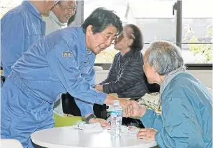  ?? AP ?? Japan’s Prime Minister Shinzo Abe visits a shelter for people affected by Typhoon Hagibis, in Motomiya, Fukushima prefecture yesterday.