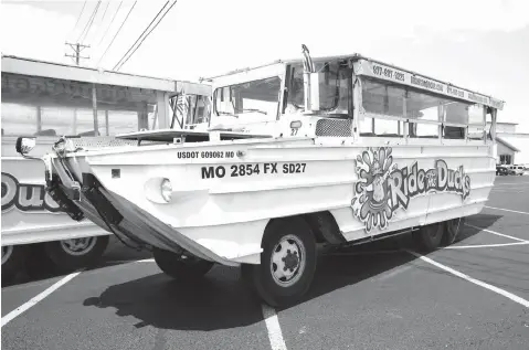  ?? Charlie Riedel/Associated Press file photo ?? ■ A duck boat sits idle July 20 in the parking lot of Ride the Ducks, an amphibious tour operator in Branson, Mo. A lawsuit seeking $100 million in damages was filed Sunday, July 29, against the owners and operators of a duck boat that sank July 19.