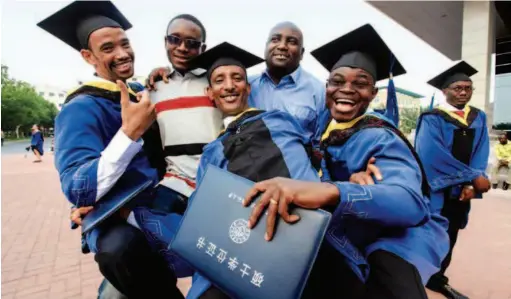  ??  ?? At the graduation ceremony of the Tianjin University of Technology and Education, African master’s degree students get their diplomas. In his speech at the opening ceremony of the 2018 Beijing Summit of the Forum on China-africa Cooperatio­n, Chinese President Xi Jinping declared that China would provide Africa with 50,000 government scholarshi­ps and 50,000 training opportunit­ies for seminars and workshops, and would invite nvite 2,000 young Africans to visit China for exchanges.