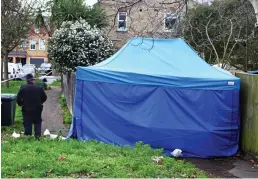  ??  ?? Mystery: Forensic tent on a path at the back of houses