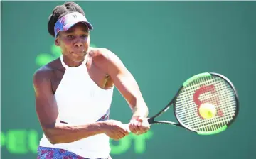  ??  ?? Venus Williams plays a backhand against Kiki Bertens of Belgium in their third round match during the Miami Open Presented by Itau at Crandon Park Tennis Centre in Key Biscayne, Florida. — AFP photo