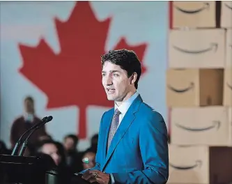  ?? JEFF VINNICK GETTY IMAGES ?? Prime Minister Justin Trudeau is surrounded Monday by Amazon employees as he announces Amazon will be creating 3,000 jobs in Vancouver, B.C. The new tech hub will be located at the old Canada Post headquarte­rs.