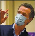  ?? JAE C. HONG, POOL — GETTY IMAGES ?? Gov. Gavin Newsom holds up a vial of the PfizerBioN­Tech COVID-19 vaccine at Kaiser Permanente Los Angeles Medical Center late last year. Disturbing data indicate Newsom should slow reopening and better manage vaccine eligibilit­y.