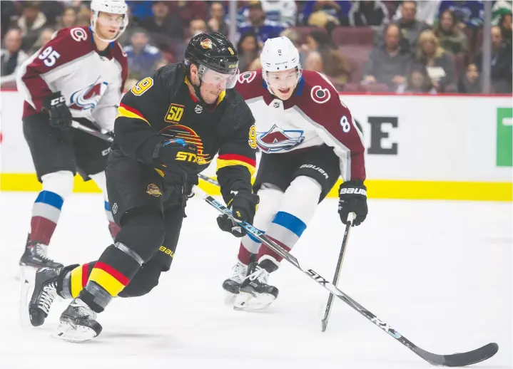  ?? GERRY KAHRMANN/PNG FILES ?? Colorado Avalanche rookie-of-the-year candidate Cale Makar, right, challenges Canucks’ J.T. Miller as the Avs’ Andre Burakovsky follows the play.