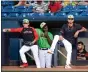  ?? DANE GARDNER — FOR THE NEWS-HERALD ?? Captains players look on from the dugout May 13.