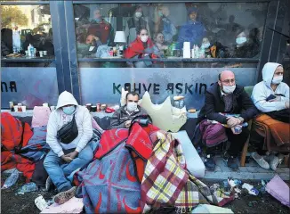  ?? KEMAL ASLAN / REUTERS ?? People watch rescue operations after an earthquake struck the Aegean Sea, in the coastal province of Izmir, Turkey, on Saturday.