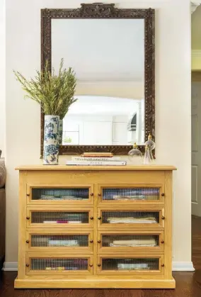  ??  ?? |ABOVE LEFT| CUSTOMIZED COOL. “This custom-made cabinet has a French-antique vibe, but we added a modern touch with muted glass,” Jennifer says. The choice was functional too. The cabinet contains napkins and tablecloth­s for entertaini­ng, so it’s easy for the homeowner to find what she’s looking for, and it doesn’t look too cluttered.