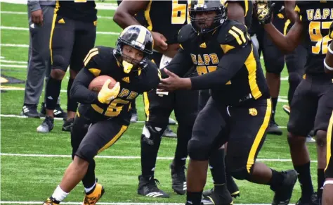  ?? (Pine Bluff Commercial/I.C. Murrell) ?? UAPB running back Omar Allen Jr. takes a handoff during warm-ups before an April 17 home game against Prairie View A&M.