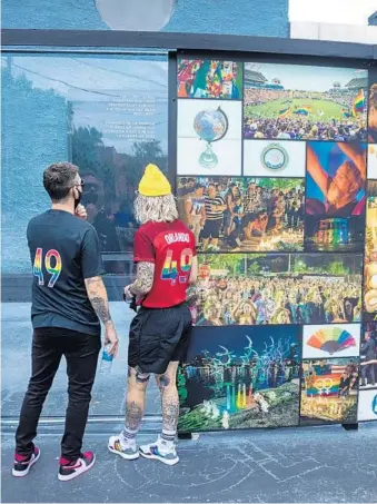  ?? MARK THOR/ORLANDO PRIDE ?? Pride coach Marc Skinner, left, and goalkeeper Ashlyn Harris, right, visit the Pulse nightclub memorial on Thursday. The team followed the visit with social media posts honoring the 49 people killed four years ago.