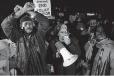  ?? Patrick Lantrip/Associated Press ?? Protesters lead chants of “hands up, don’t shoot” Friday while blocking traffic on the Interstate 55 bridge in Memphis, Tenn.