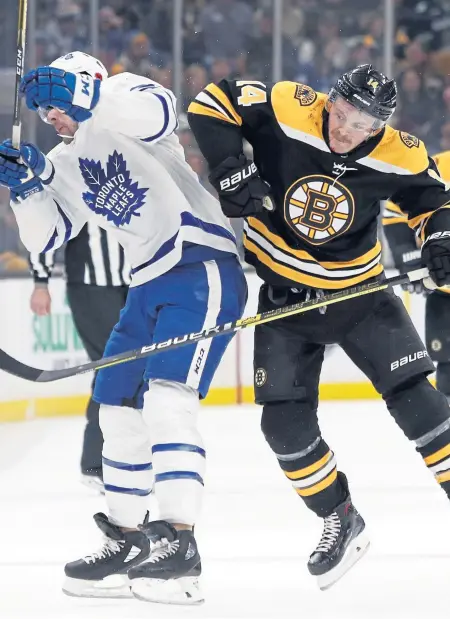 ?? ASSOCIATED PRESS ?? TAKE THAT! Chris Wagner checks the Maple Leafs’ Frederik Gauthier during the Bruins’ 5-1 victory last night at the Garden.