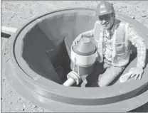  ??  ?? ’ Namgis salmon farm operations manager Cathal Dinneen stands in one of the floor drains used to removed solid waste from the grow- out tanks.