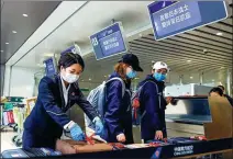  ??  ?? Medics arrive at the check-in desk of China Southern Airlines, heading to Wuhan in the fight against the COVID-19 outbreak.