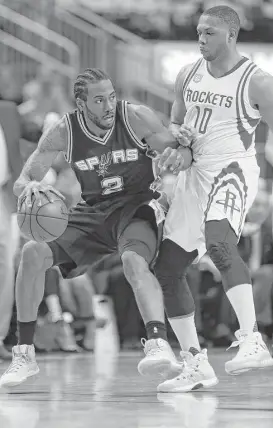  ?? Karen Warren / Houston Chronicle ?? Spurs forward Kawhi Leonard (2) pushes against Rockets guard Eric Gordon (10) during the second half of Game 3. The Spurs overcame the loss of veteran Tony Parker to take a 2-1 series lead.