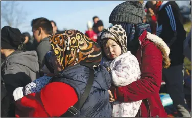  ?? (AP/Emrah Gurel) ?? Migrants gather Monday at a field near Edirne, Turkey, on the country’s border with Greece.