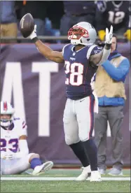  ?? Elise Amendola / Associated Press ?? Patriots running back James White, right, celebrates his touchdown run as Bills safety Micah Hyde sits on the turf during the first half on Sunday.