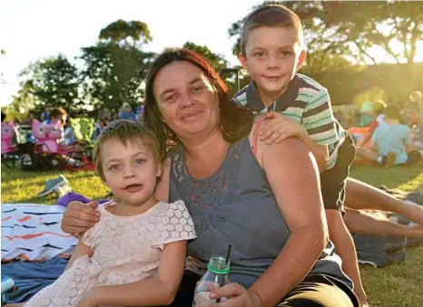  ?? PHOTO: KEVIN FARMER ?? MOVIE NIGHT: Excited for the entertainm­ent to begin are (from left) Emily, Kristy and Isaac Seipel at Rangeville State School movie night.