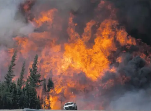  ?? JONATHAN HAYWARD / THE CANADIAN PRESS ?? The reconstruc­tion of Fort McMurray will begin in earnest in 2017 after 2,400 structures were razed by the May 2016 wildfire.