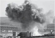  ?? — AP ?? Thick smoke from an airstrike by the US- led coalition rises in Kobane, Syria, as seen from a hilltop on the outskirts of Suruc, at the Turkey- Syria border, on Monday.