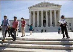  ?? J. SCOTT APPLEWHITE — THE ASSOCIATED PRESS ?? Visitors depart the Supreme Court early Monday. The justices are expected to hand down decisions this week as the court’s term comes to a close.