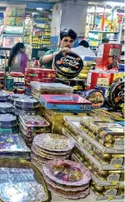  ?? AFP ?? A worker arranges gift boxes at a store in Mumbai ahead of the Hindu festival Diwali.