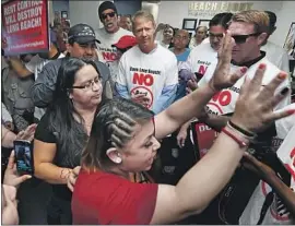  ?? Luis Sinco Los Angeles Times ?? RENTERS facing eviction and opponents of rent control face off in June at the offices of Beach Front Property Management in Long Beach.