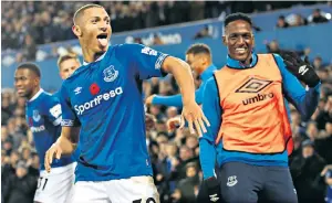  ??  ?? Brazilian flair: Richarliso­n celebrates after netting a brace to see off Brighton