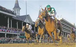  ?? DARRON CUMMINGS/ASSOCIATED PRESS ?? Joel Rosario rides Accelerate to victory Saturday in the Breeders’ Cup Classic at Churchill Downs in Louisville, Ky.