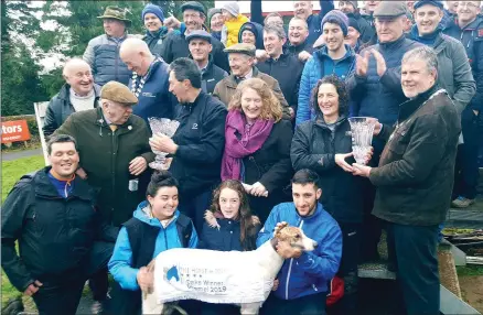  ?? Photo by Moss Joe Browne ?? Jubilant scenes in Clonmel on Tuesday afternoon after Ballymac Enya won the Oaks at the National Coursing meeting. Winning owner/trainer Liam Dowling accepted the trophy from sponsor Tom Egan.