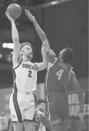  ?? JAMIE SQUIRE/GETTY ?? Drew Timme #2 of the Gonzaga Bulldogs shoots the ball against Evan Mobley #4 of the USC Trojans during the first half in the Elite Eight round game of the 2021 NCAA Men’s Basketball Tournament at Lucas Oil Stadium on March 30, 2021 in Indianapol­is, Indiana.