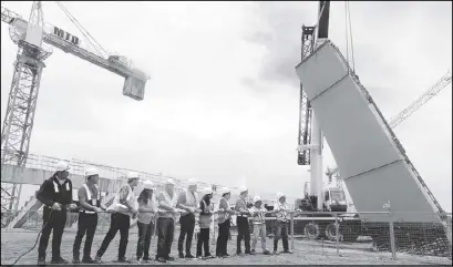  ??  ?? Philippine Sea Games organizing committee chairman Alan Peter Cayetano led the installati­on of composite columns at the New Clark City Athletic Stadium during the committee’s site visit on July 7. The Athletic Stadium is part of the world-class sports...