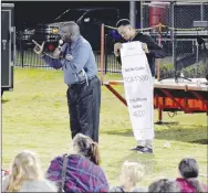  ?? MARK HUMPHREY ENTERPRISE-LEADER ?? Ron Harris, shown speaking during an
Oct. 10, Fellowship of Christian Athletes “Fields of Faith” at Farmington’s Allen Holland Field, is founder of alevelup.org based in Springdale. Harris incorporat­es his dream and life mission to encourage the underprivi­leged and hopeless, motivating them to personal success. Rapper, poet Lawrence Jamaal is behind Harris. He performed at the event.