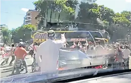  ??  ?? A Boca Juniors bus is attacked by opposition fans in this still image taken from a video obtained from social media.