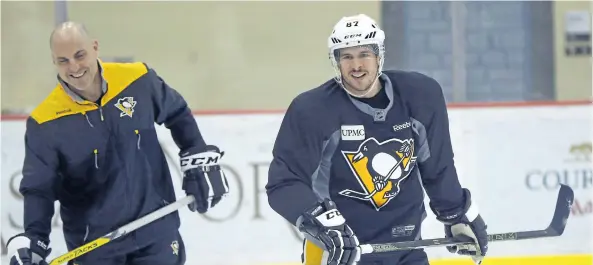  ?? KEITH SRAKOCIC/AP ?? Pittsburgh’s Sidney Crosby skates past assistant coach Rick Tocchet during team practice on Friday. It’s still uncertain whether he will be available for Game 5 on Saturday night in Washington.