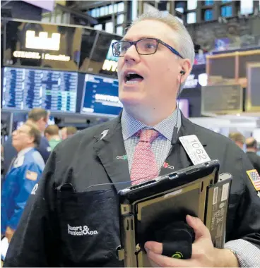  ?? Picture / AP ?? Trader Eric Schumacher gets busy on the floor of the New York Stock Exchange.