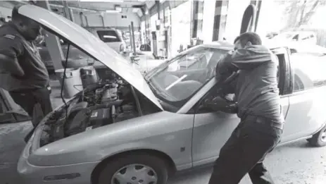  ?? G-jun Yam, The Associated Press ?? Mechanics work on car at Ted's Auto Clinic in Chicago. Word-of-mouth is still the best way to pick a garage.