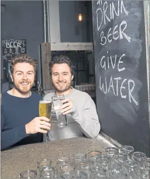  ??  ?? RAISING A GLASS: Brewgooder founders Alan Mahon and Josh Littlejohn toast the beer and water.