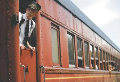  ?? STAFF FILE PHOTO BY DOUG STRICKLAND ?? Conductor Augustus Frye looks from the window of a rail car as it leaves the station at a previous Railfest at the Tennessee Valley Railroad Museum.