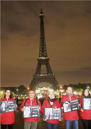  ?? AFP ?? A dark issue: Reporters Without Borders rememberin­g the world’s slain journalist­s in front of Eiffel Tower, which was turned off to commemorat­e the Internatio­nal Day to End Impunity for Crimes against Journalist­s. -